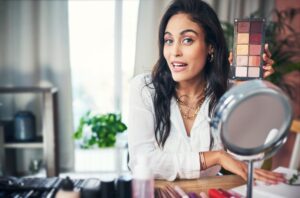 Shot of a influencer recording a makeup tutorial for her blog at home