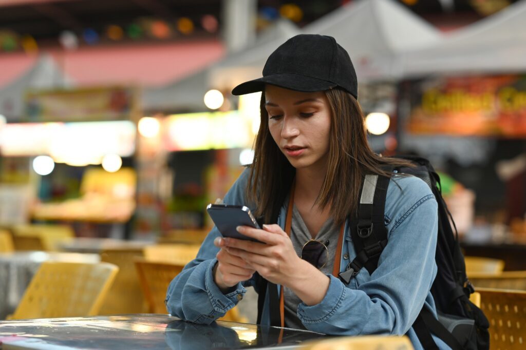 Beautiful caucasian young woman messaging on smart phone, ways content helps create a better user experience, content marketing, improve user experience