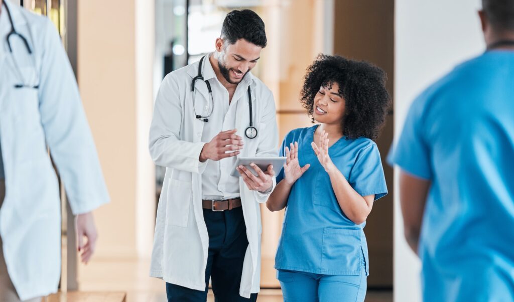 Shot of two young doctors using a tablet and having a discussion in a modern office