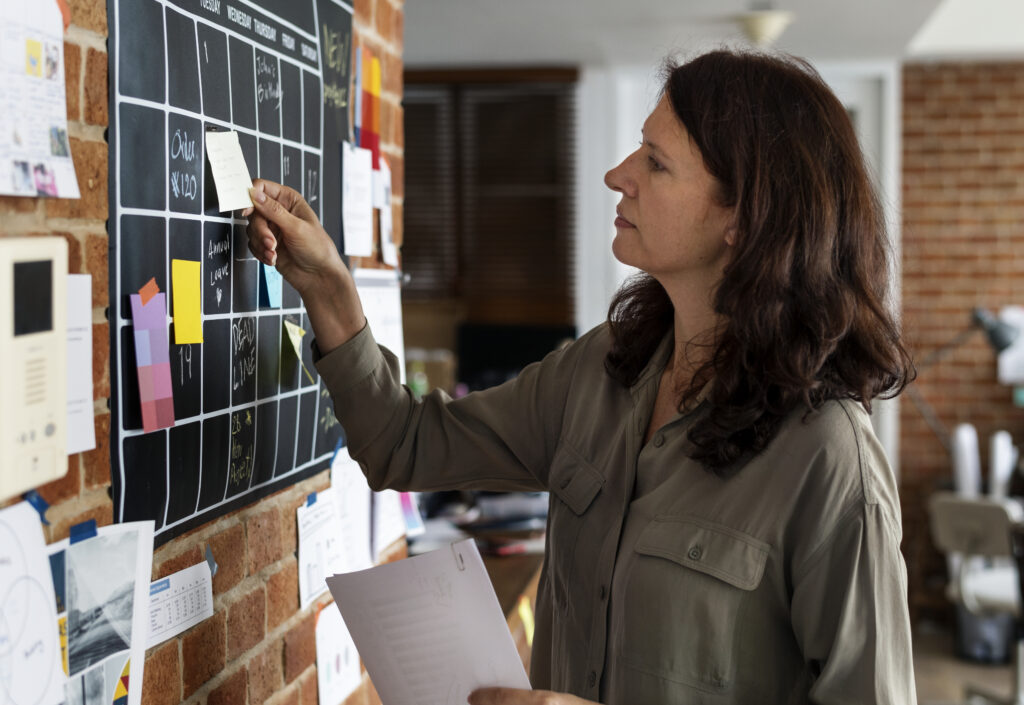 Woman pulling sticky note