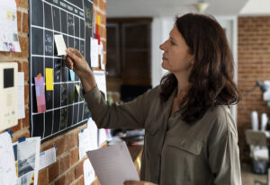 Woman pulling sticky note