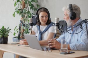 female and male podcasters record audio content in sound studio. social media, news program on radio Media Landscape in 2024