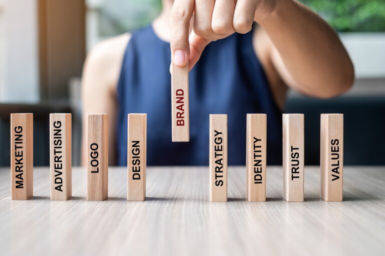 Businesswoman hand placing wooden Dominoes with text